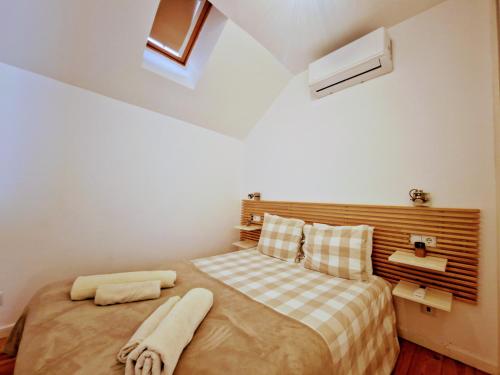a bedroom with a bed with two towels on it at Mouraria Studios & Flats by Lisbon Village Apartments in Lisbon
