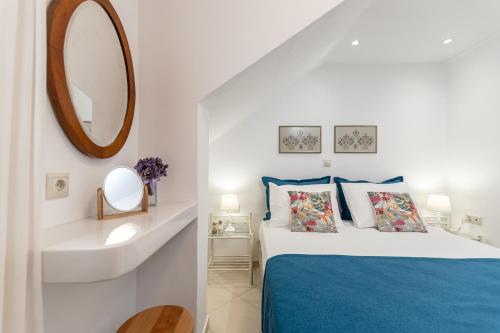 a bedroom with a bed and a sink and a mirror at Amaranto Naxos 2 in Naxos Chora