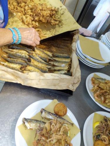 a table with plates of food on a table at Hotel San Francisco Spiaggia in Rimini