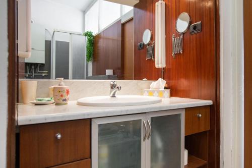 a bathroom with a sink and a mirror at Penthouse apartment with private parking in Zagreb