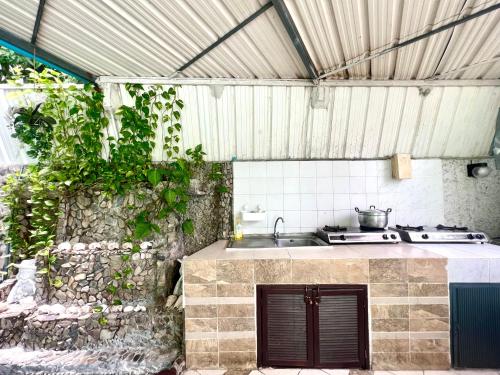 an outdoor kitchen with a sink and a stove at NN Apartment in Pattaya South