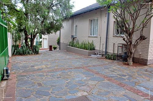 a stone driveway in front of a house at THE GLOBAL LINK HUB in Pretoria