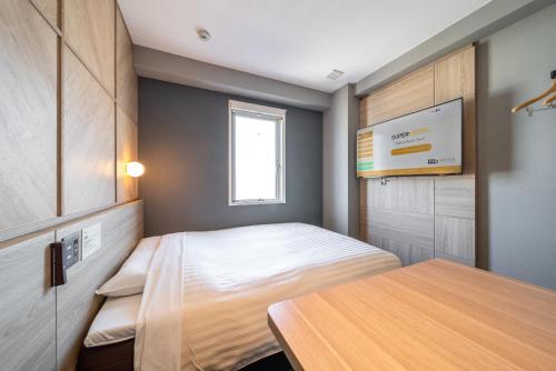 Ein Bett oder Betten in einem Zimmer der Unterkunft Super Hotel Shikoku-chuo