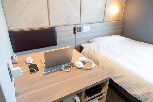Ein Bett oder Betten in einem Zimmer der Unterkunft Super Hotel Shikoku-chuo