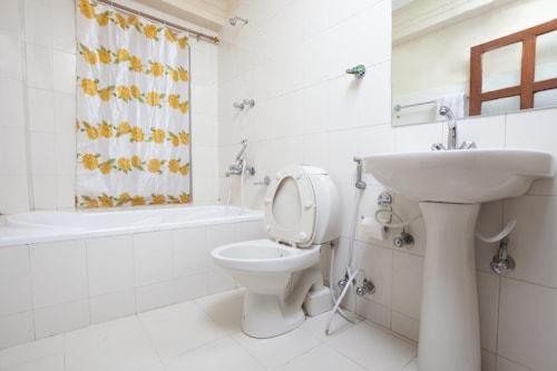a white bathroom with a sink and a toilet at Nagarkot Sunshine Hotel in Nagarkot