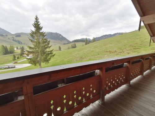 a balcony with a view of a green field at Haus Obweg - Postalm in Hallein