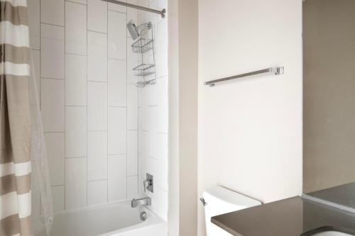 a bathroom with a shower and a sink at Shaw jr 1br w gym wd pool nr restaurants WDC-681 in Washington, D.C.