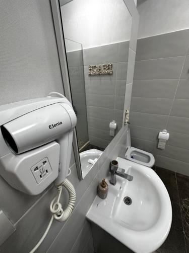 a bathroom with a sink and a mirror and a toilet at Ayan Luxury By Complex Almar in Mamaia Sat/Năvodari