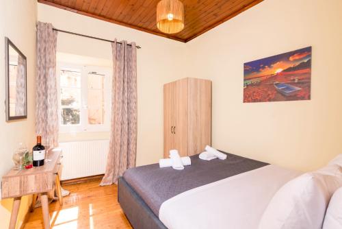 a bedroom with a bed and a window at Tenedos old town in Corfu Town