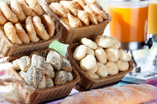 a bunch of baskets filled with different types of bread at Holiday Inn Express - Sindelfingen by IHG in Sindelfingen