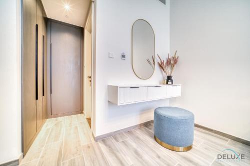 a room with a blue stool and a mirror at Exquisite 2BR with Assistant Room at Mesk 1 Midtown Dubai Production City by Deluxe Holiday Homes in Dubai