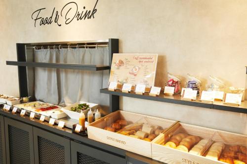 a bakery with bread and other food items on display at ICI HOTEL Ueno Shin Okachimachi in Tokyo