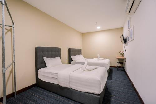 Postel nebo postele na pokoji v ubytování 3C HOTEL Setia Walk Puchong