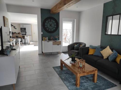 un salon avec un canapé et une table dans l'établissement Maison Ville avec Patio entre Mer & Campagne, à Bacqueville-en-Caux
