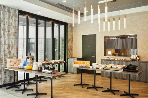 a kitchen with two tables with food on it at ICI HOTEL Tokyo Hatchobori in Tokyo