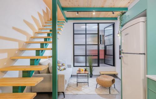 a staircase in a room with a couch and a table at Cozy Studio in Old Town in Tel Aviv