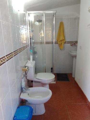 a bathroom with a toilet and a shower and a sink at por ahora no aceptan in Güimar