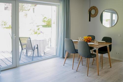 a dining room with a table and chairs at Under The Pine in Engure