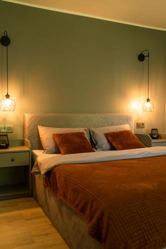 a bedroom with a bed with two pillows on it at Under The Pine in Engure