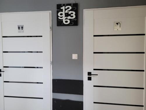 two doors in a room with black and white at Sebar in Gorzyce