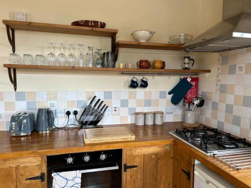 a kitchen with a stove and a counter top at Flat 2, Cliff Road in Sheringham