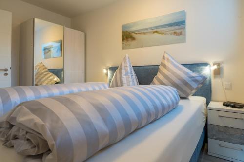 a bedroom with two beds with pillows on it at Fewo Schröder - Tolle in Norderney