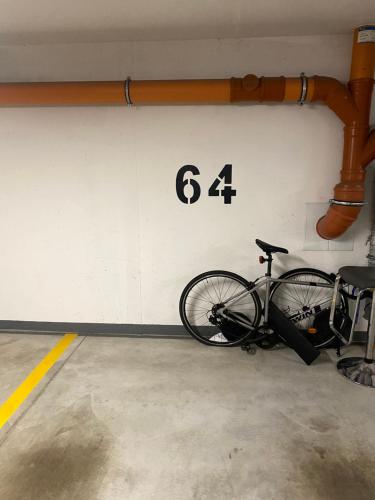 a bike parked against a wall with the number at Gdynia Hill in Gdynia