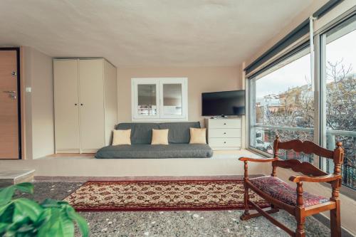 a bedroom with a bed and a large window at Eptalofos Studio loft in Thessaloniki