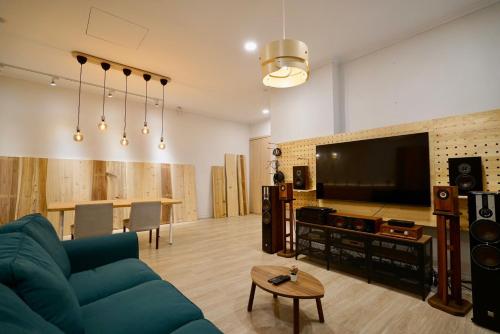 a living room with a couch and a flat screen tv at TokuGawa Hotel in Shuili