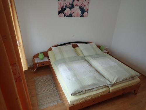 a bed sitting in a room with at Gemütliche Ferienwohnung in der Lüneburger Heide in Sprakensehl