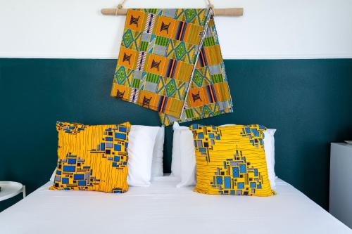 a bedroom with a bed with yellow pillows at Kumba At Koum Kapi in Chania Town