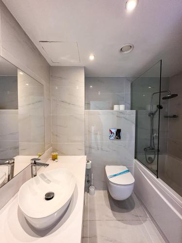 a bathroom with a sink and a toilet and a shower at Silver Sands Beach Hotel in Protaras
