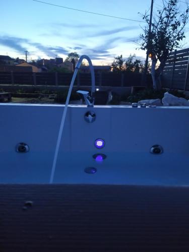 a bathtub with a faucet and a purple light at Nikos' Home in Gastourion