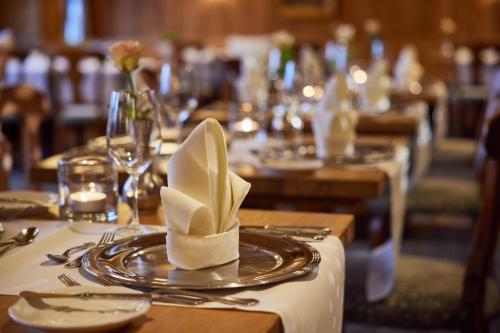 a table set up for a meal with a napkin on top of it at Parkhotel Oberstaufen in Oberstaufen