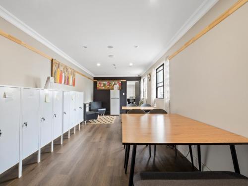 an office with lockers and a table in a room at Azzurro Boutique Hotel - Surry Hills in Sydney