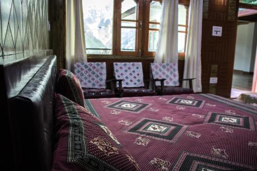 a room with chairs and a bed in a train at Aaruhee Homestay in Kalpa