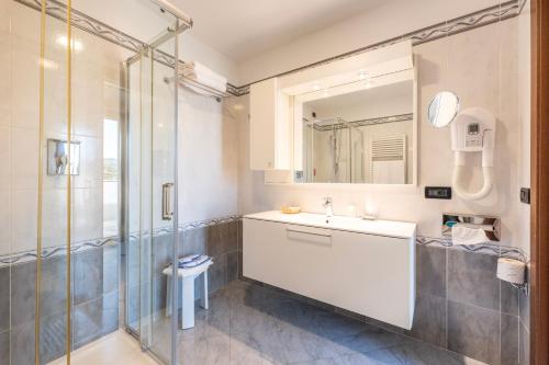 a bathroom with a sink and a shower at Hotel Bellevue Et Mediterranée in Diano Marina