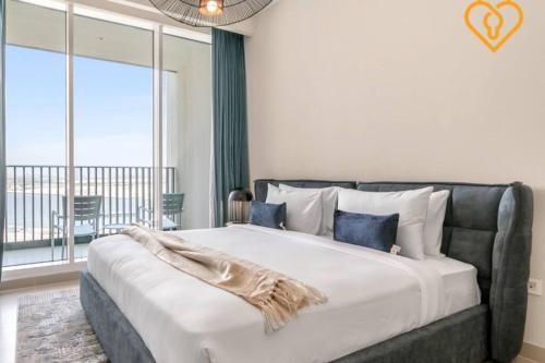a bedroom with a large bed with a large window at Keysplease Spectacular Views Modern 1BR Creek Gate 602 in Dubai