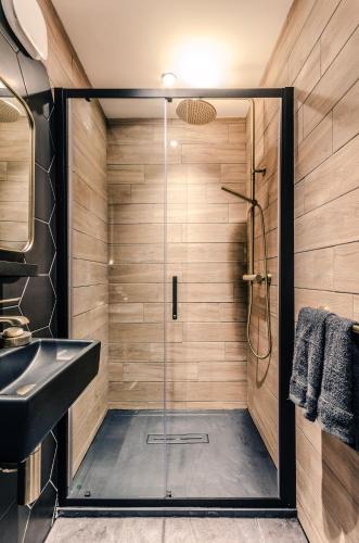 a bathroom with a shower with a glass door at Sweeney Aviemore One in Aviemore