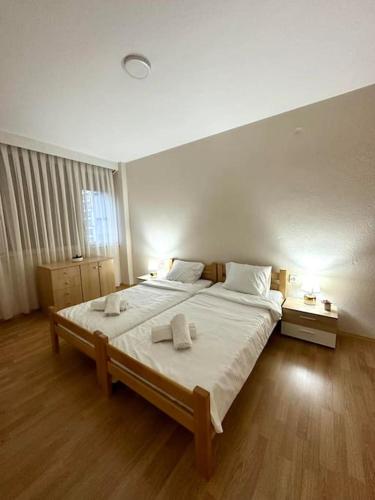 a bedroom with a large bed with two towels on it at Lakeside apartment in Struga