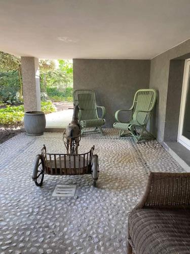a room with two chairs and a toy car in the middle at Casa Cuniolo Guest House in Tortona