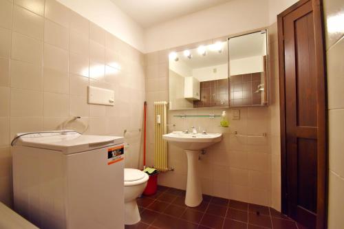 La salle de bains est pourvue d'un lavabo, de toilettes et d'un miroir. dans l'établissement Presanella Trilocale, à Madonna di Campiglio
