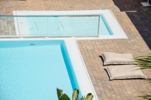 an empty swimming pool next to a house at Hotel Anfora Ibiza in Es Cana