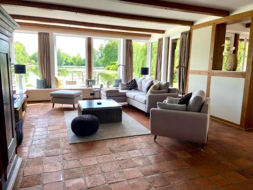 a large living room with couches and a table at Landhaus Lotten in Winsen Luhe