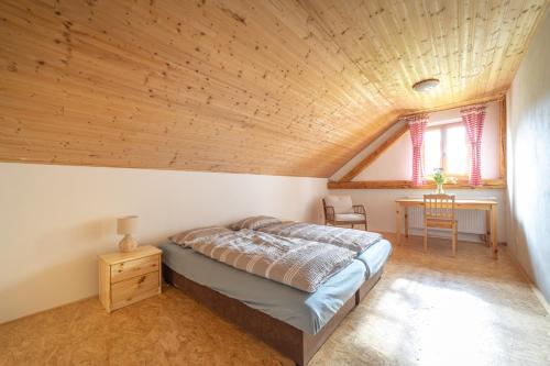 a bedroom with a bed and a wooden ceiling at Chata Hermann - Vernířovice in Vernířovice