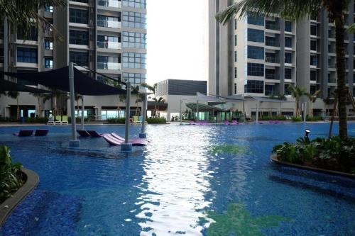 a swimming pool in the middle of a city with buildings at Cozy Haven Atlantis with Large Swimming Pool in Melaka