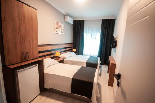 a hotel room with two beds and a window at MiLAROOM in Edirne