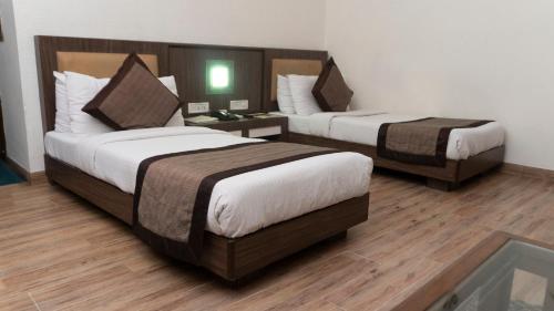 a hotel room with two beds in a room at Mg Regency in Baddi