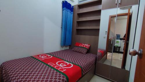 une petite chambre avec un panneau cocacola sur un lit dans l'établissement OKA ROOM, à Kayuringin