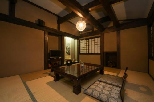 a living room with a table and a couch at Iroriyado Hidaya in Takayama